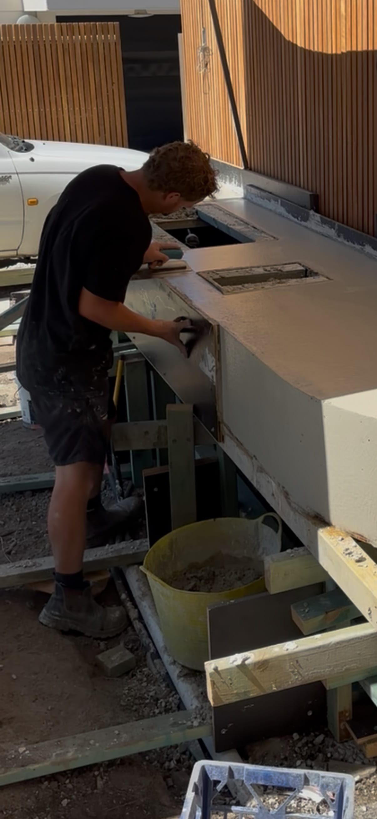 Craftsman finishing bespoke architectural concrete on site